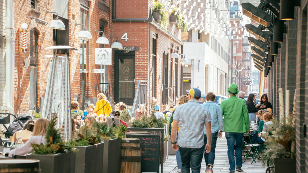 people walking through the alley at dairy block in denver