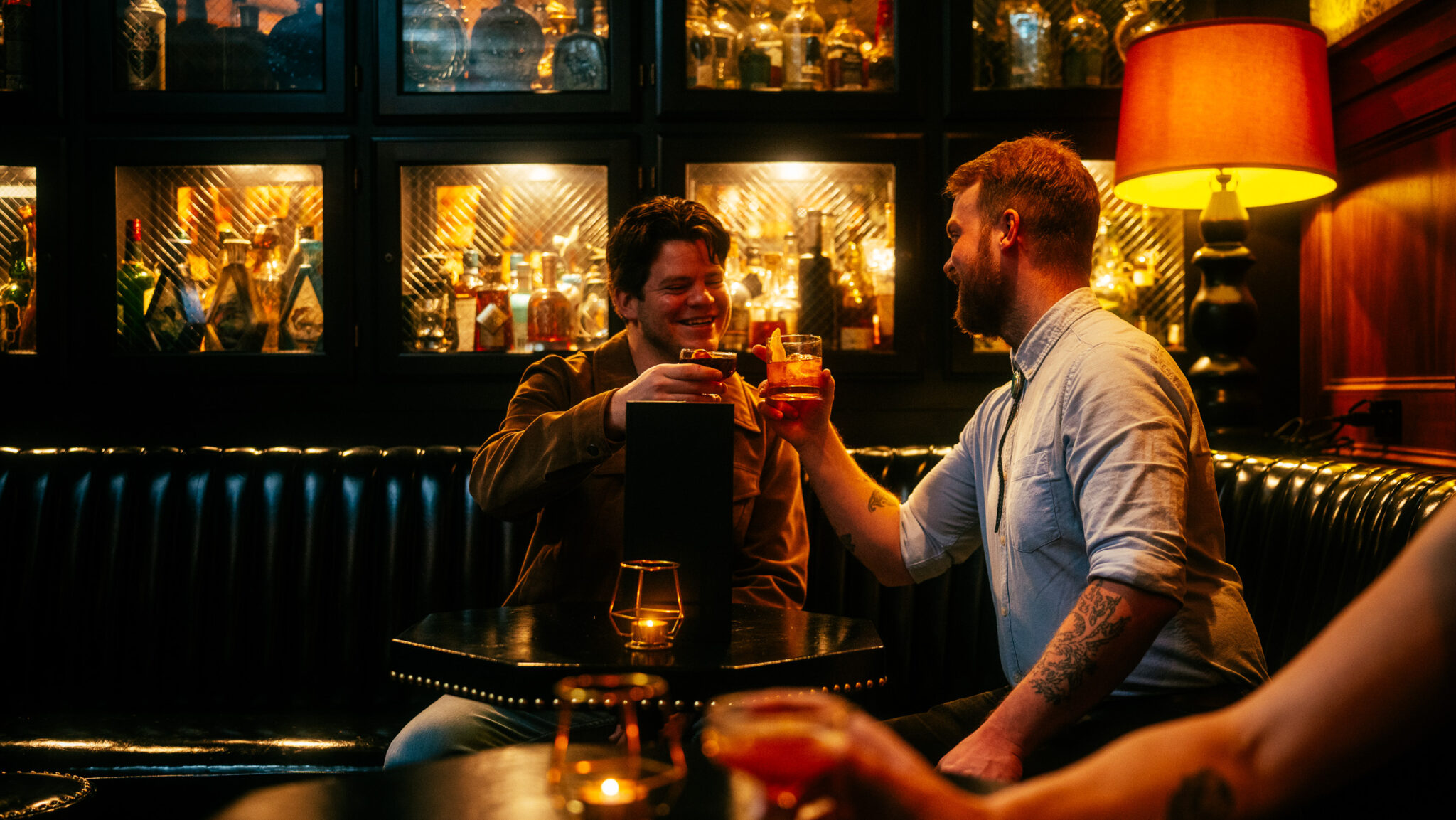 Two customers cheersing inside Seven Grand
