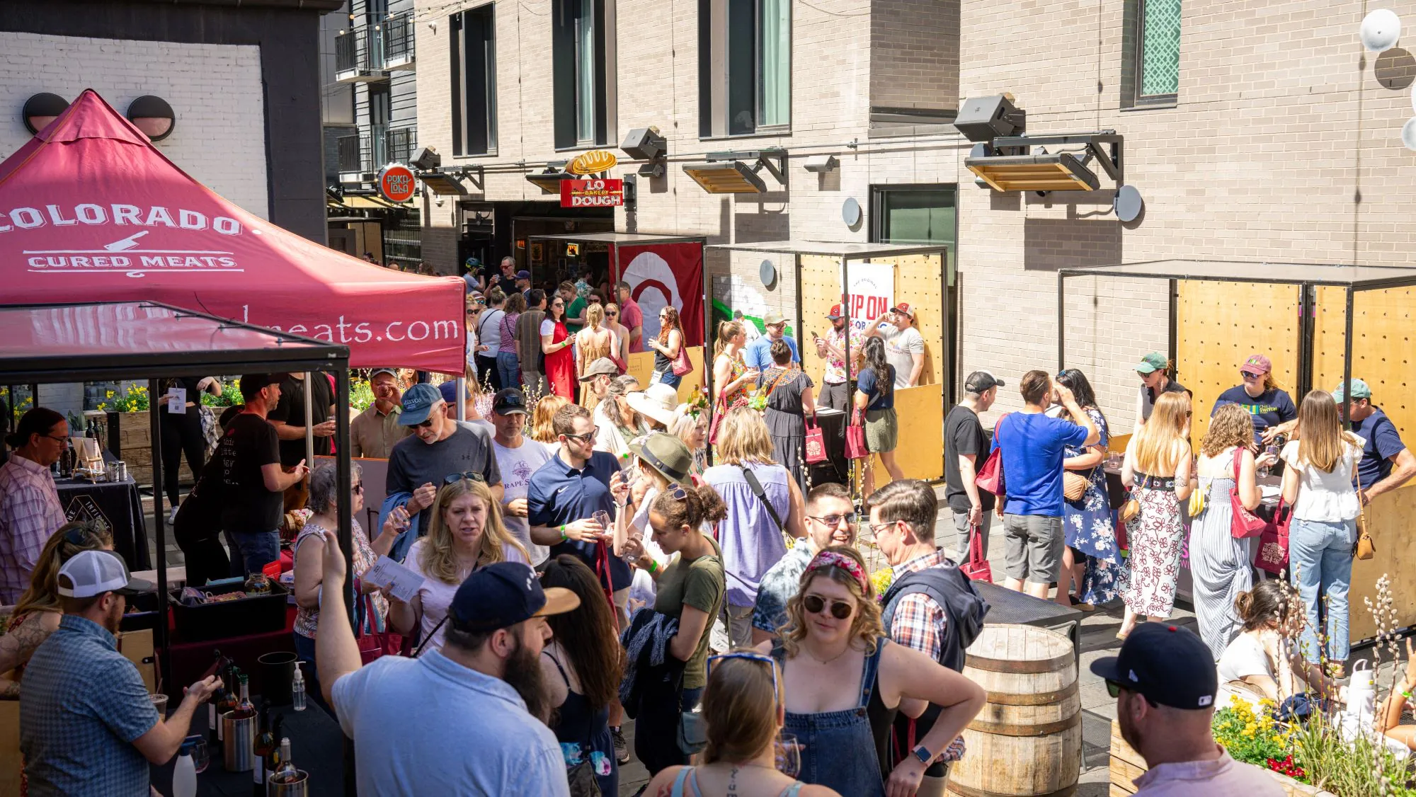 Crowd Gathering at Outdoor Craft Market with Colorado Cured Meats Tent