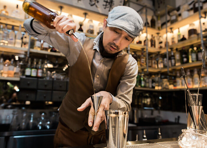 bartender crafting a cocktail at a denver bar in dairy block
