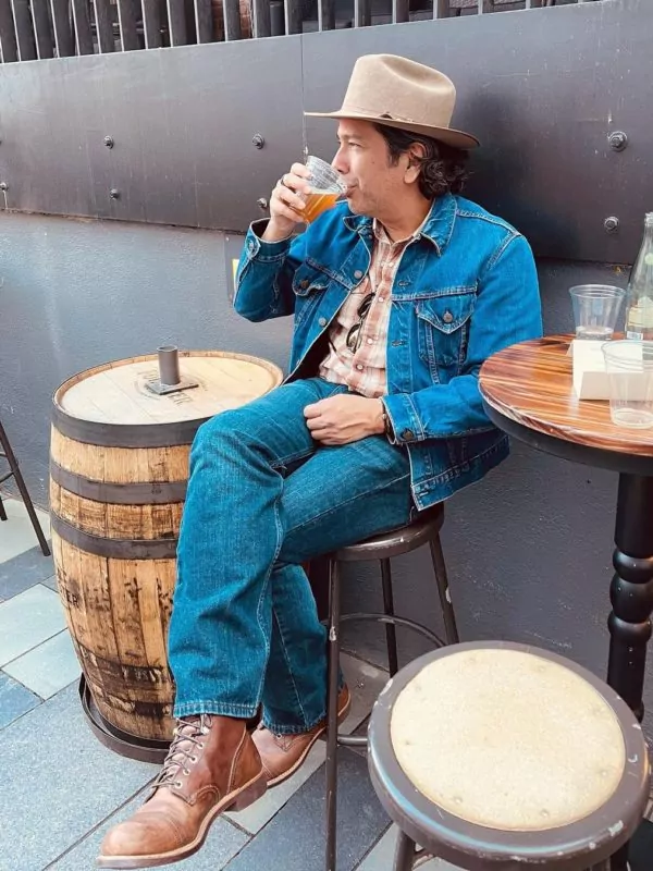 man drinking a beer in the dairy block alley denver