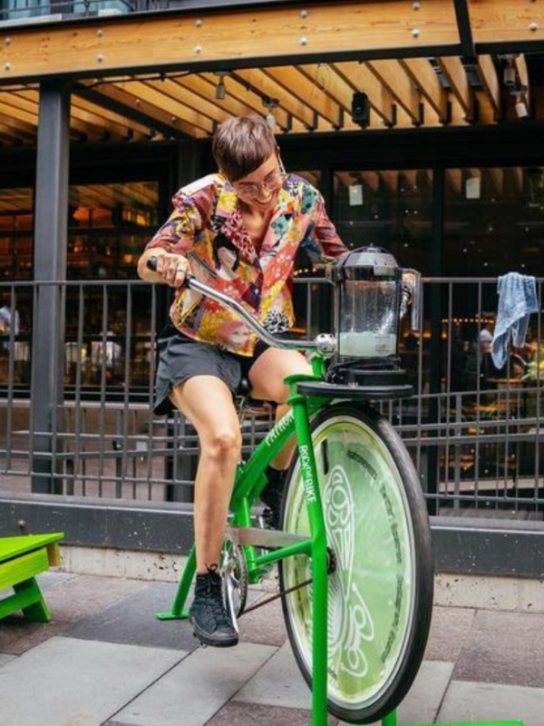 Perosn riding bike that powers a smoothie blender