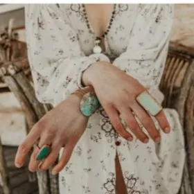 Woman with crossed arms wearing turquoise rings