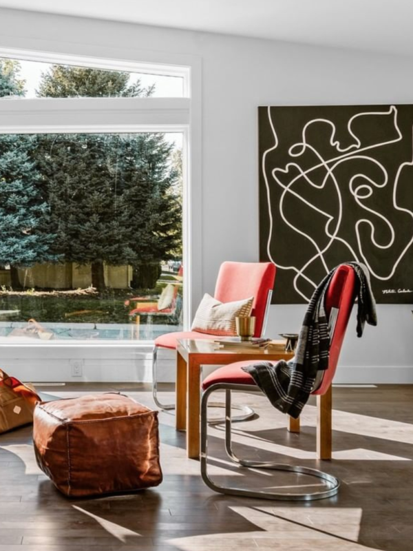 sunny living room with two red chairs