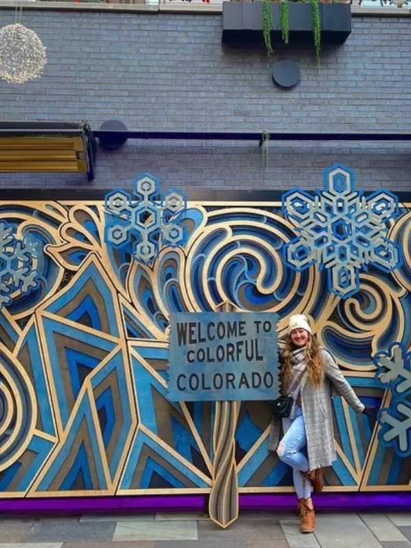 woman posing in front of art at dairy block denver