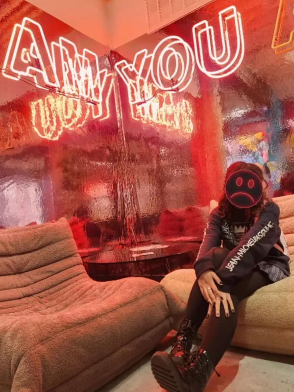 woman sitting near an art installation at dairy block denver
