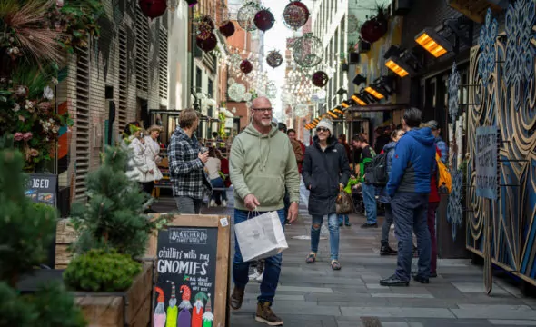 holiday market with shoppers in the dairy block alley