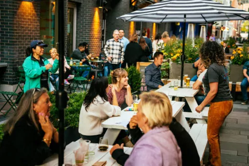 people drinking beer on a patio at dairy block