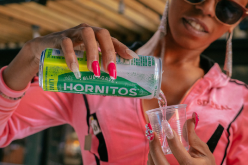 Woman pouring Hornitos canned beverage into a glass