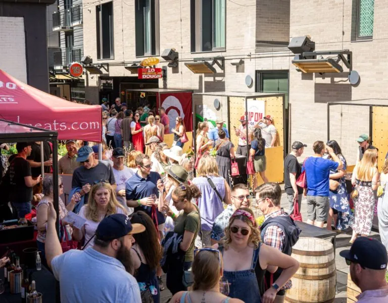 Crowd Gathering at Outdoor Craft Market with Colorado Cured Meats Tent